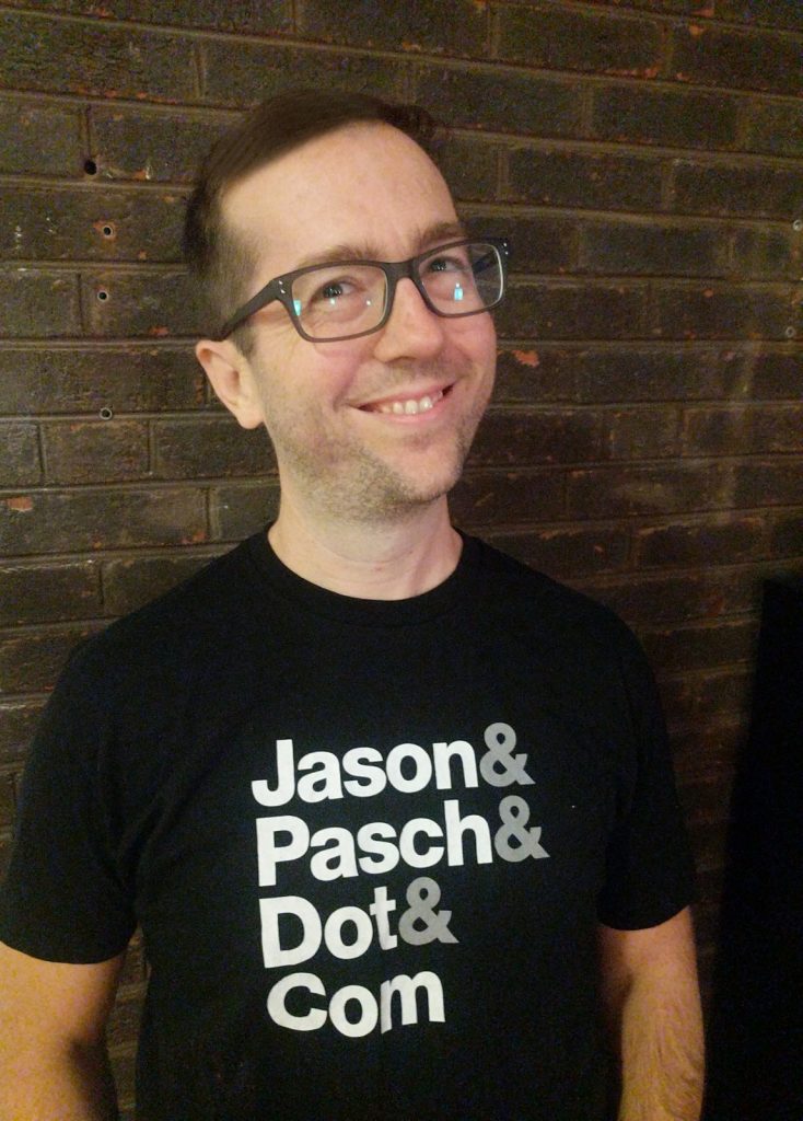 Jason Pasch in a Shirt that say Jason & Pasch & Dot & Com